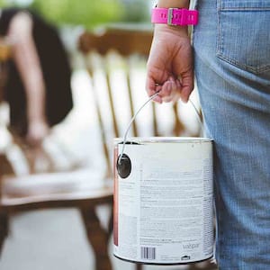 woman carrying leftover paint for new project 