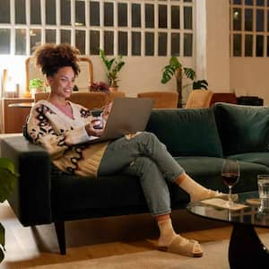 A woman using her laptop in a basement living room