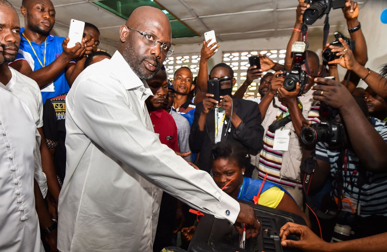 Former international Liberian football star turned politician, and three-time presidential election candidate George Weah casts his vote. <br /><br />Credit: Getty images