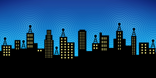 Image of a skyline of buildings with antennas on them.