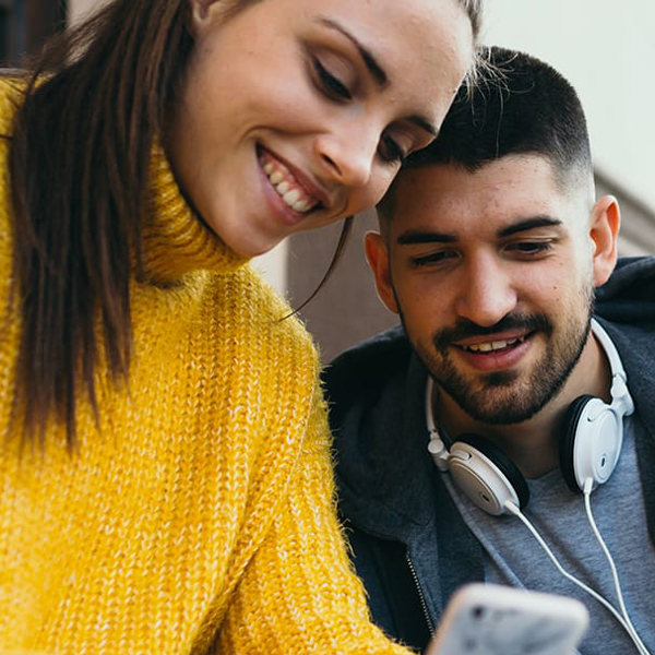 Photo of two people looking at a tablet