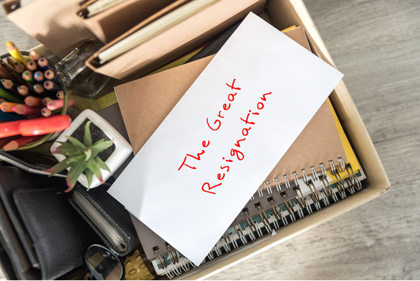 Resignation letter on top of a box of personal belongings for a work who quit a job