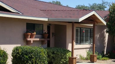 one-story house with new red roofing shingles 