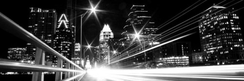 A black and white photo of Austin, from a bridge, at night