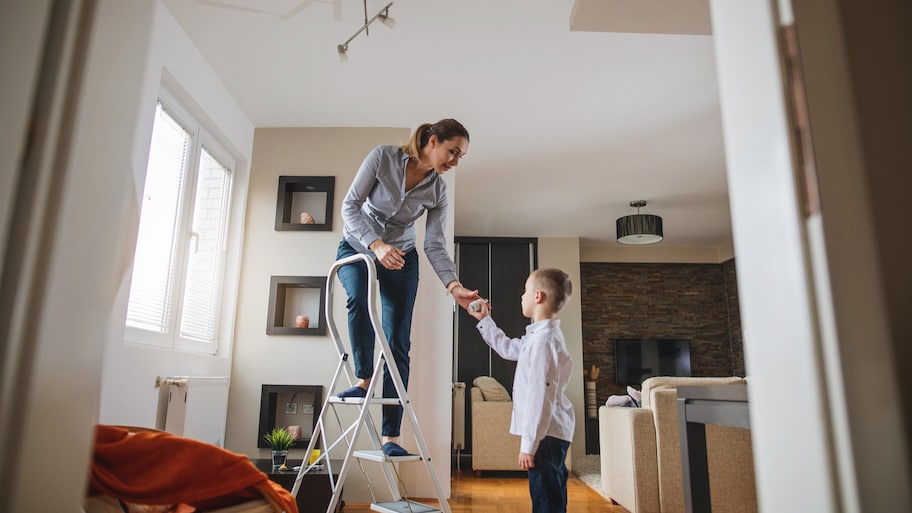  A woman learning to her child changing a light bulb