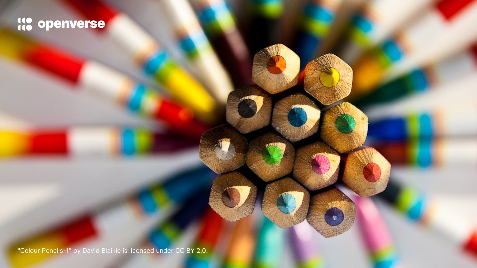 Close-up of sharpened colored pencils together on a colorful blurred background, with Openverse logo and credits "Colour Pencils-1" by David Blaikie is licensed under CC BY 2.0.