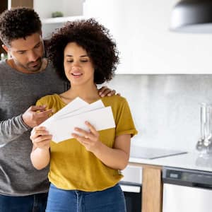 Couple at home getting letters and bills