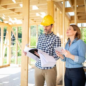 Architect and homeowner at home build site