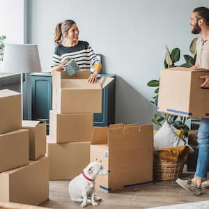 Couple in the living room packing their belongings