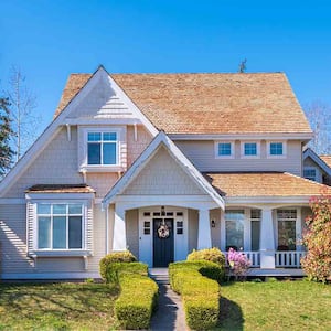 beige home with wood shingles on roof