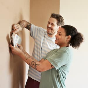 A young couple choosing paint color for their home