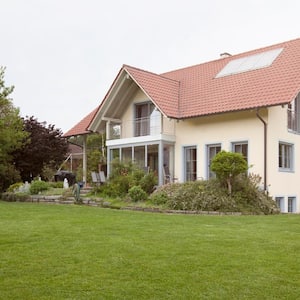 A house with a large garden with lawn