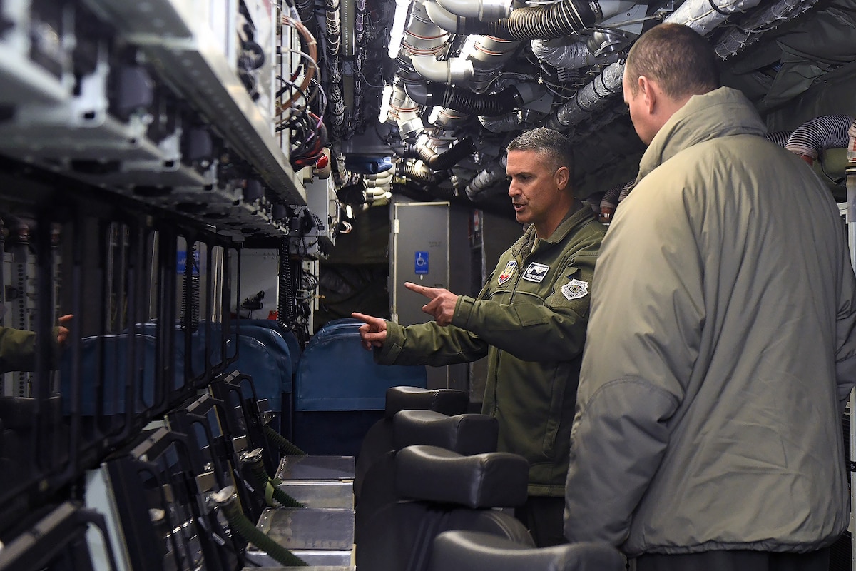 Two men in an RC-135V/W Rivet Joint aircraft