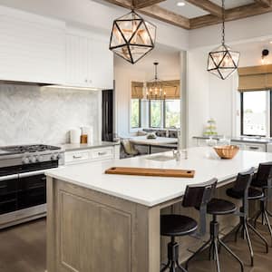 A luxurious kitchen with an island and pendant lights