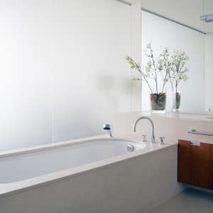 A modern bathtub in a bathroom with glass walls