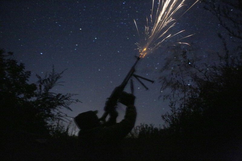 A Ukrainian serviceman fires at a drone.