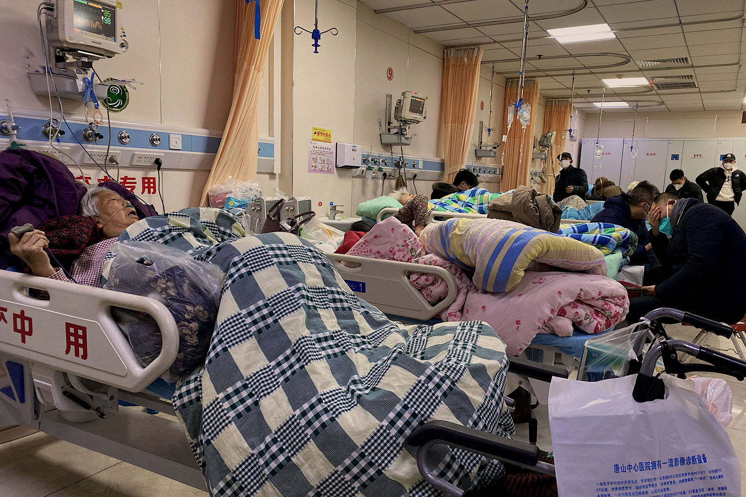 Patients with COVID-19 lie in beds at Tangshan Gongren Hospital in China's northeastern city of Tangshan.