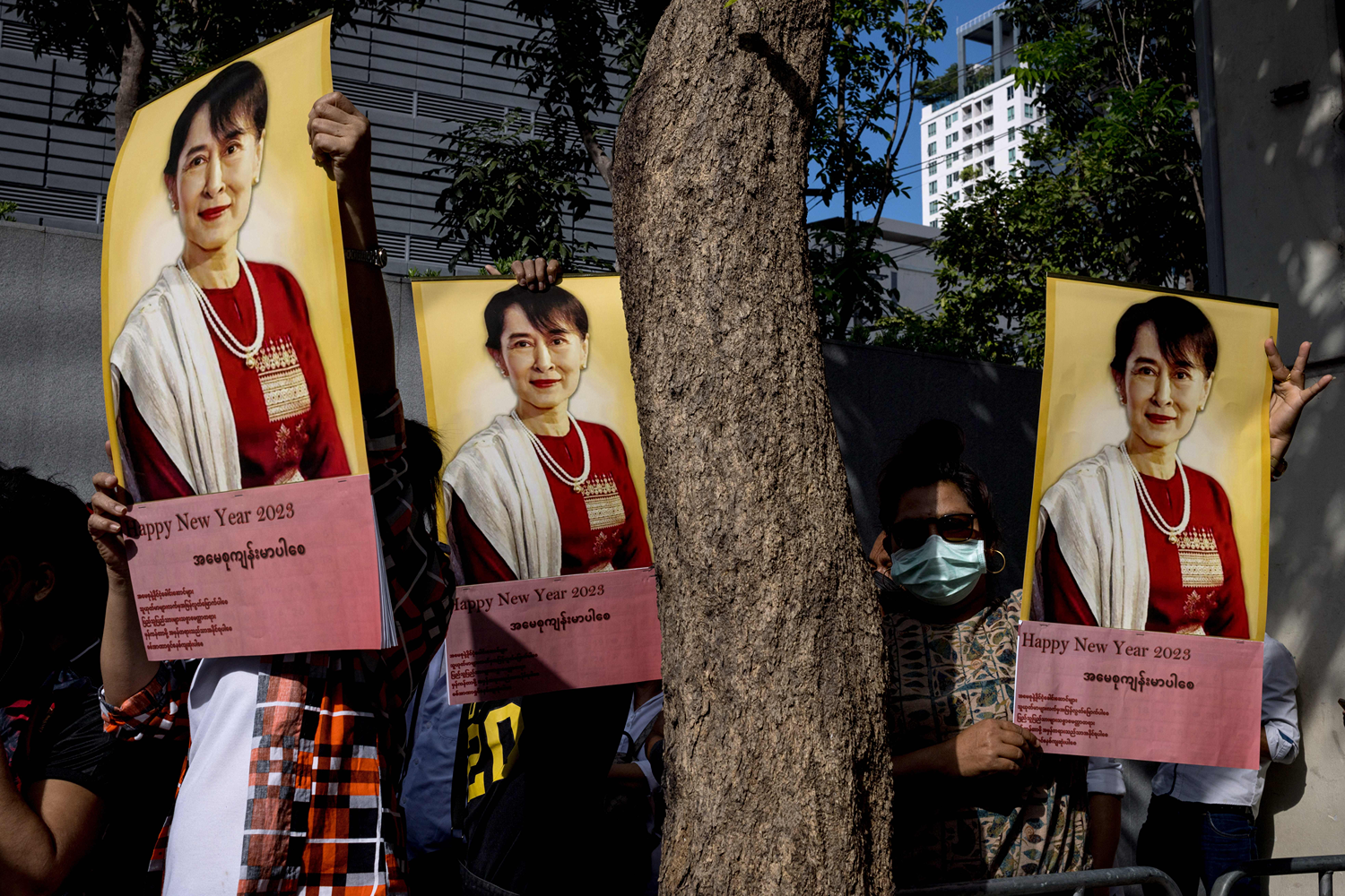 Burmese protesters hold up pictures of detained Burmese civilian leader Aung San Suu Kyi.