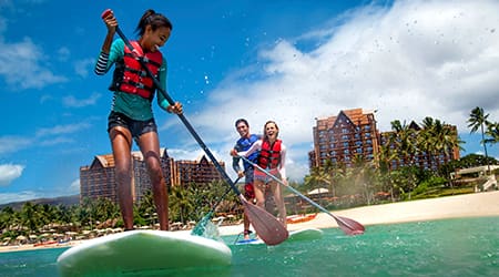 Attendees paddle surfing at Disneys Aulani Resort in Hawaii