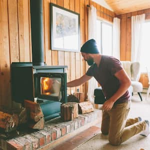 Man burning firewood at home