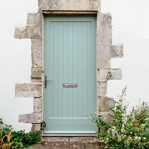 green wooden door on lintel