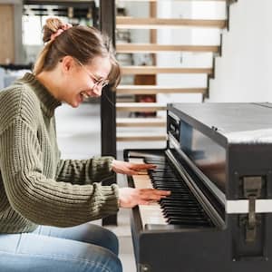 A woman playing piano in living room