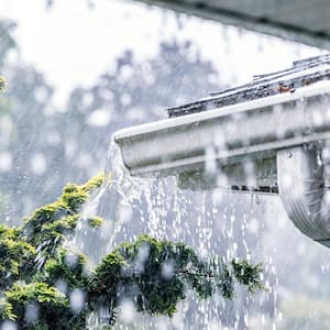 Summer rain overflowing roof gutters