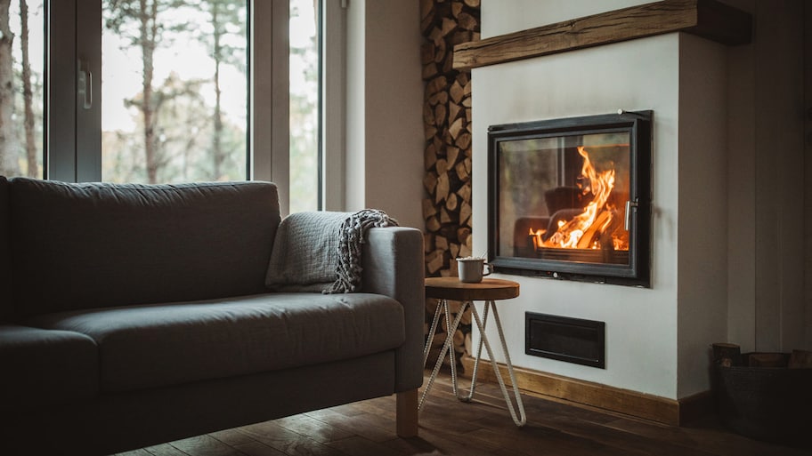 A cozy living room with a burning fireplace