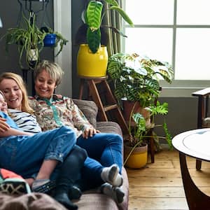 Family resting on sofa