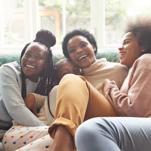 A woman embracing girls at home