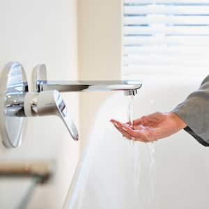 Woman checking water temperature before taking a bath