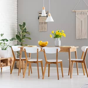 A stylish dining room with a bookcase in the background