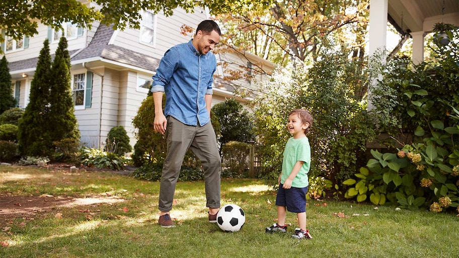 Father and son playing in yard