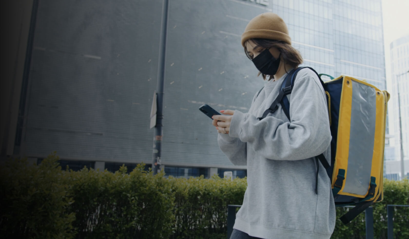 A courier delivering a package using Mapbox Navigation.