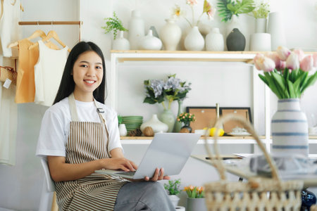 Business owner smiling happily looking at the camera with be happy when reading news online.