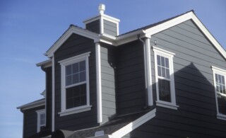 Suburban house with grey siding and white trim