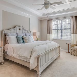 A carpeted bedroom painted in light tones