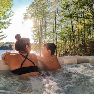 Boy and his mom relaxing in a cottage hot tub