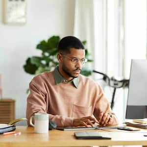 Man using desktop PC at desk