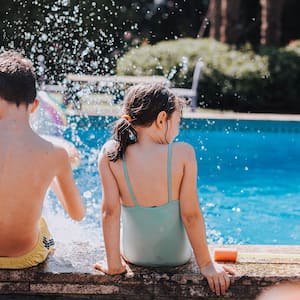 Kids splashing on side of pool