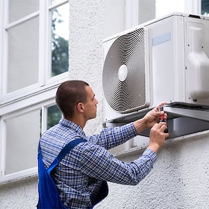 Professional repairing window air conditioner from outside