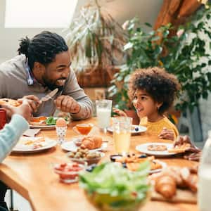 A family of four having lunch at their dining table