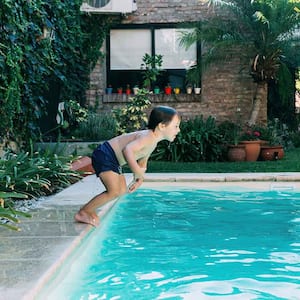 Little boy jumping in the swimming pool