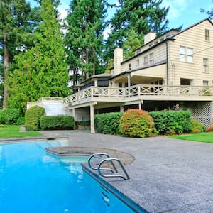 A house with a large garden and a swimming pool