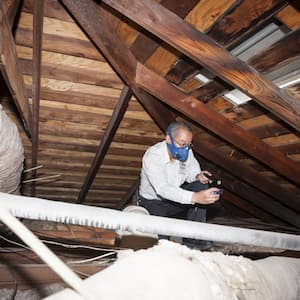 home inspector checking attic