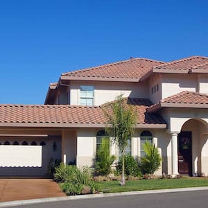 Villa style house with clay tile roof