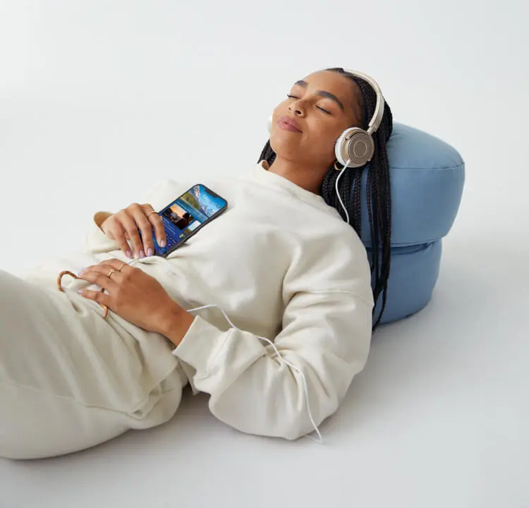 Person laying on a pillow listening to Calm