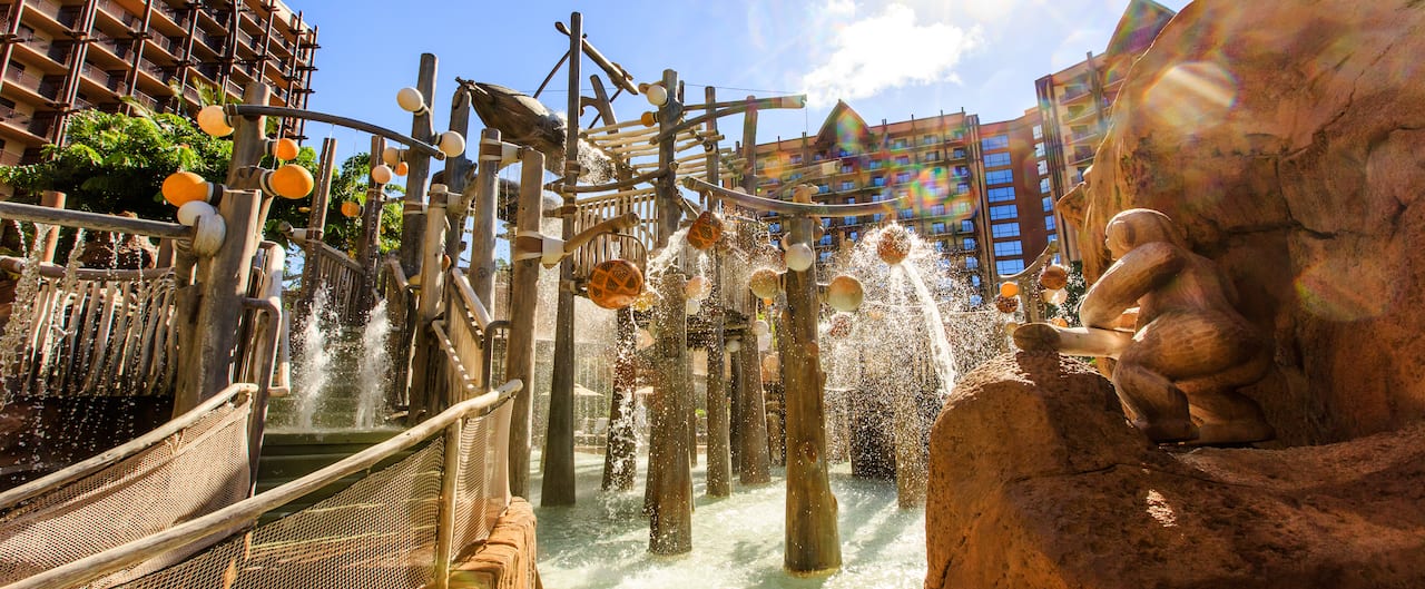 Water spills down from the Menehune Bridge as the Resort's rooms and suites tower in the background