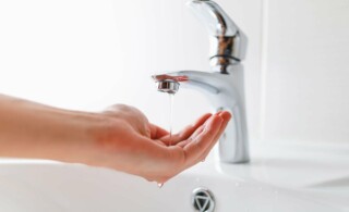 hand under sick checking water pressure