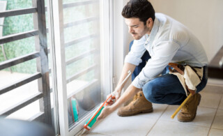 Man applying sealant to window frame